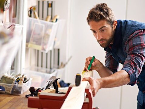 ManMeasuringPieceofWood-e1651176154167