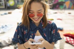 Young woman on beach checking phone