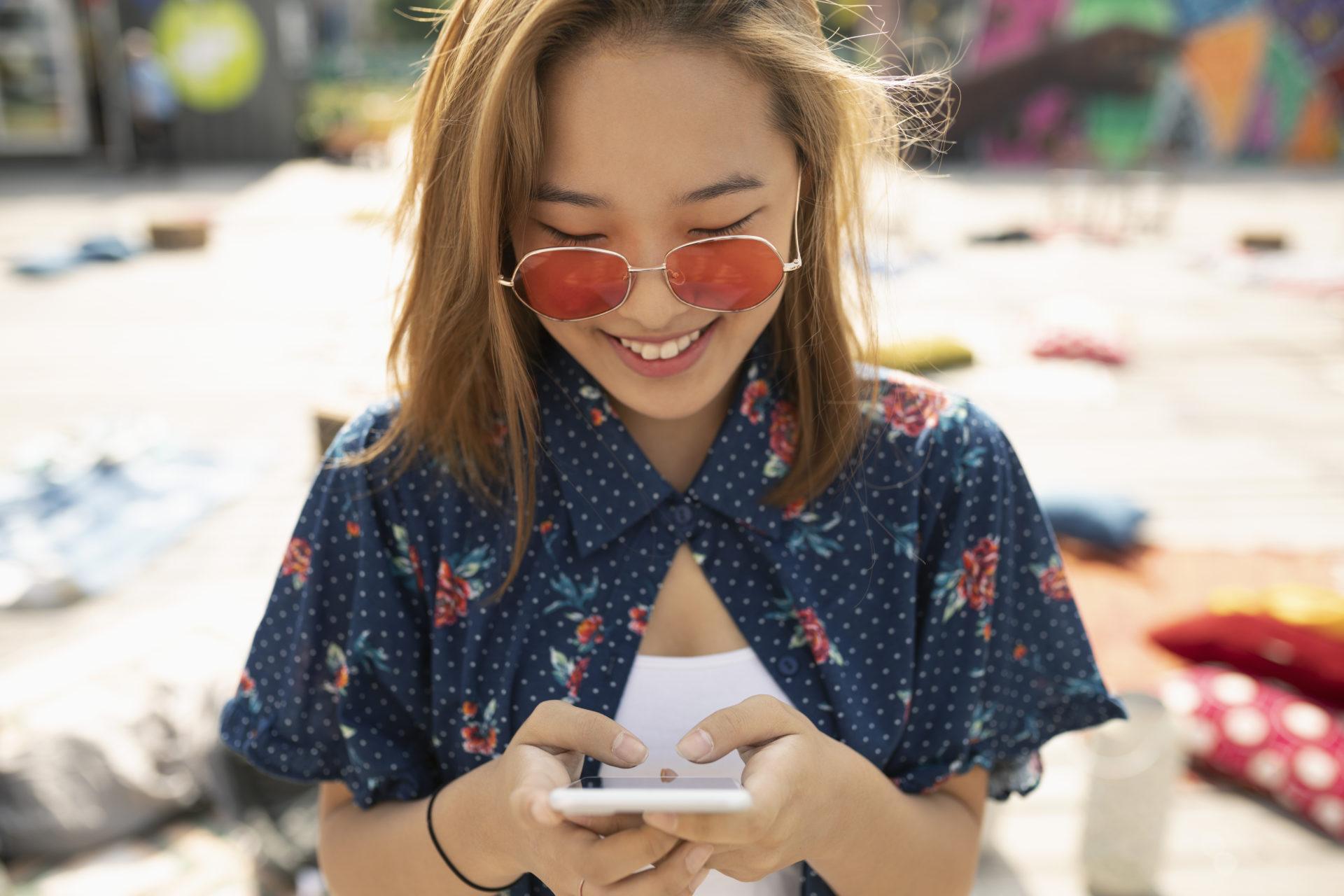 Young woman on beach checking phone