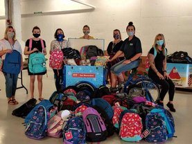 Service CU staff pack backpack donations